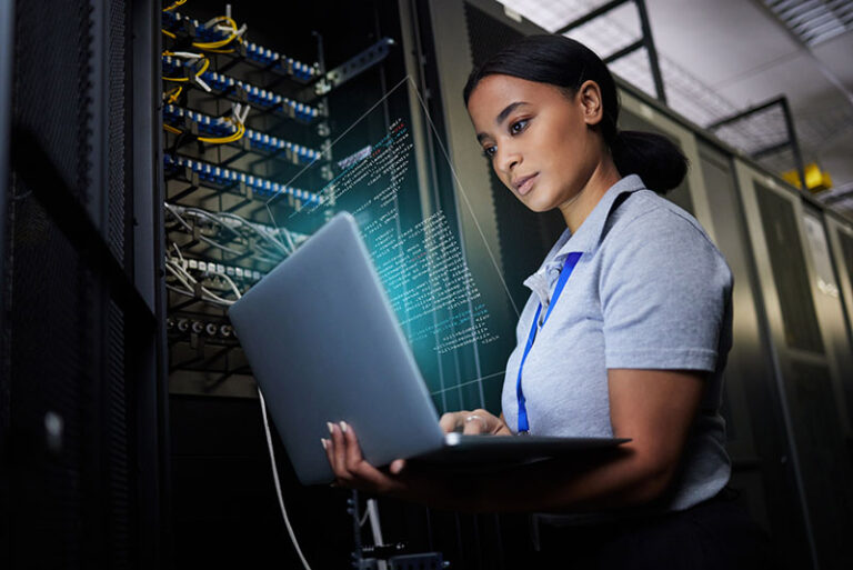 woman looking at computer checking an IT network