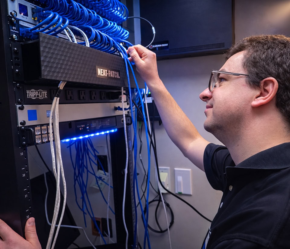 Network Engineer Managing Ethernet Cables Server Rack